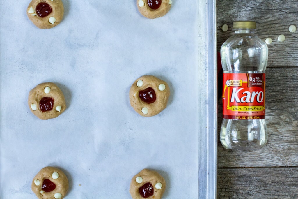 raw guava cookie dough balls on parchment paper lined pan