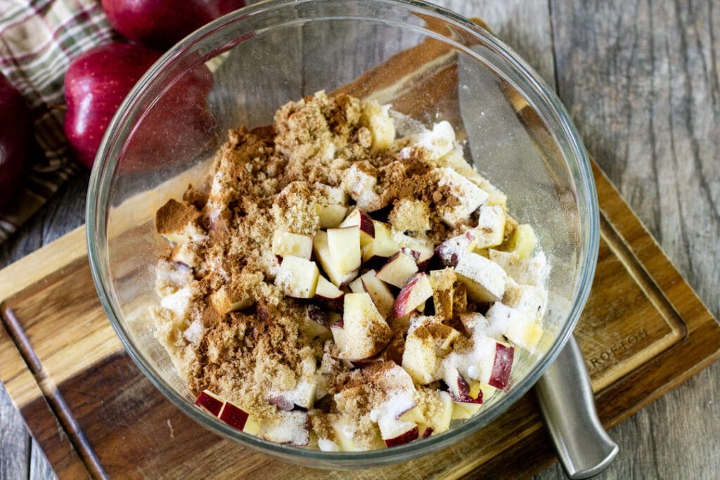 chopped apples and spices in a glass bowl
