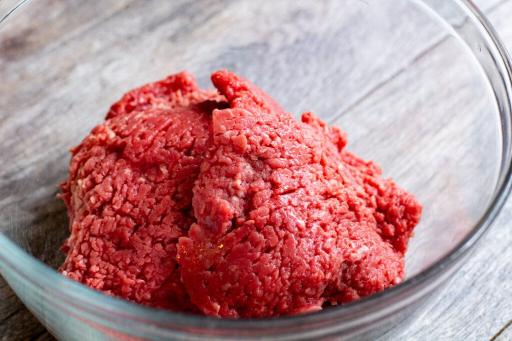 raw cube steak in a glass bowl