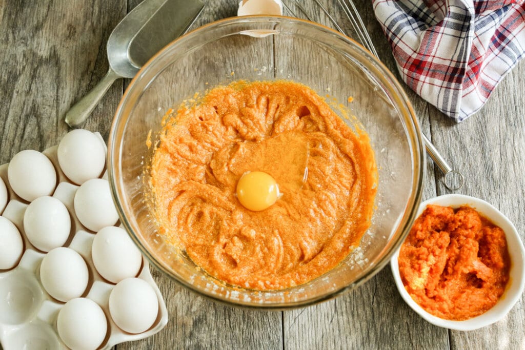 pumpkin puree with raw egg in mixing bowl
