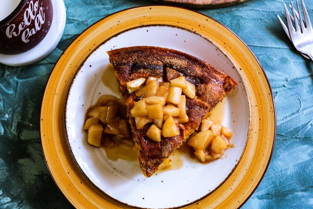 overhead shot of a slice of apple cake with carameled apple chunks