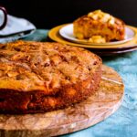 Pumpkin apple cake on a brown serving platter.