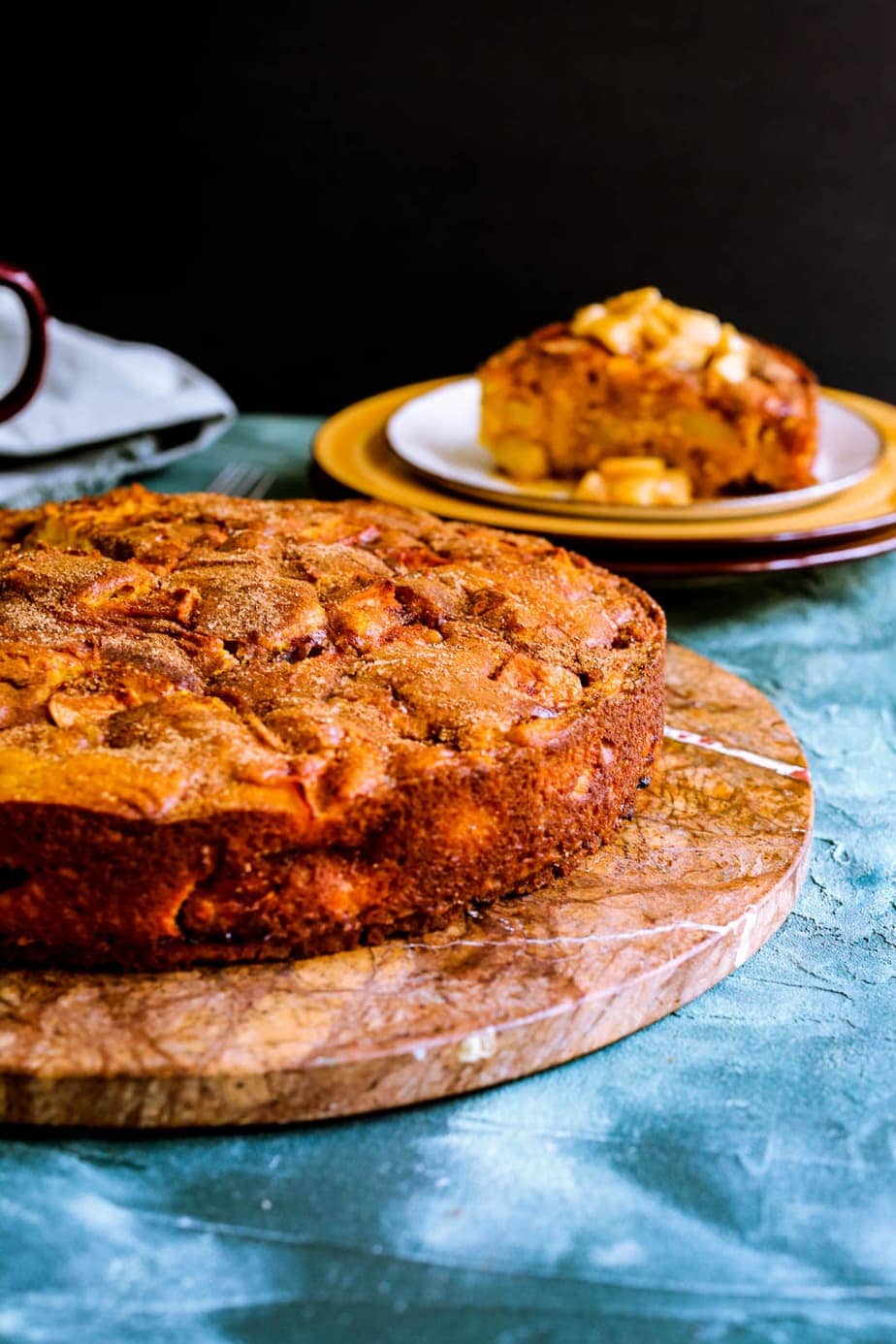 Pumpkin apple cake on a brown serving platter.