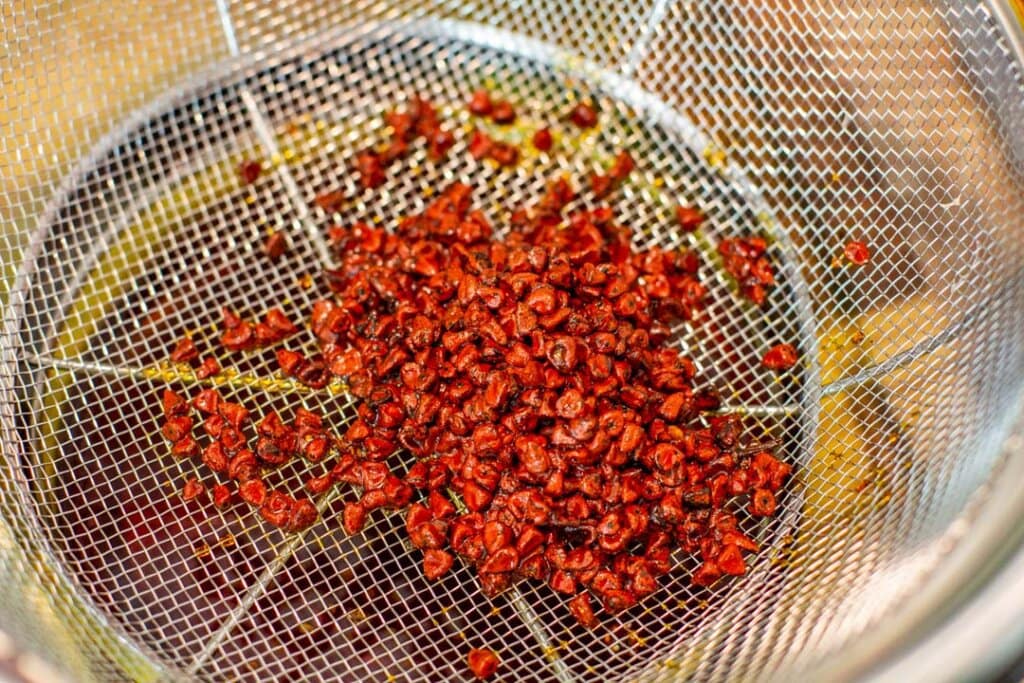 cooked achiote on strainer