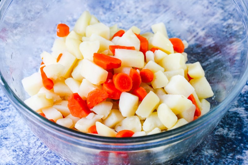 cooked potatoes and carrots in a glass bowl