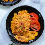 overhead shot of spanish rice on a black plate
