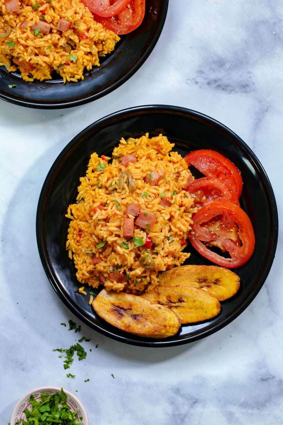 overhead shot of spanish rice on a black plate