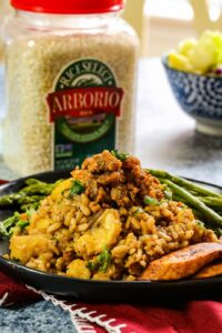 risotto with chorizo and asparagus on a black plate