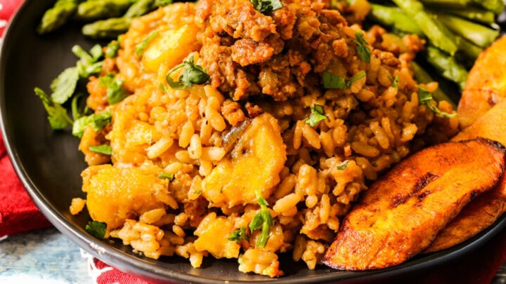 close up shot of plantains and risotto on a black plate