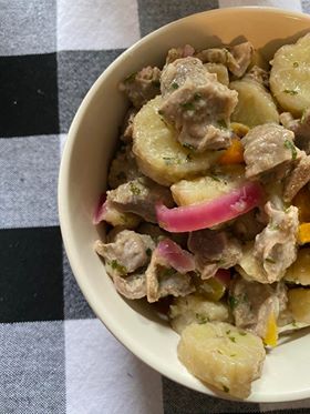 gizzards and green bananas in a white bowl