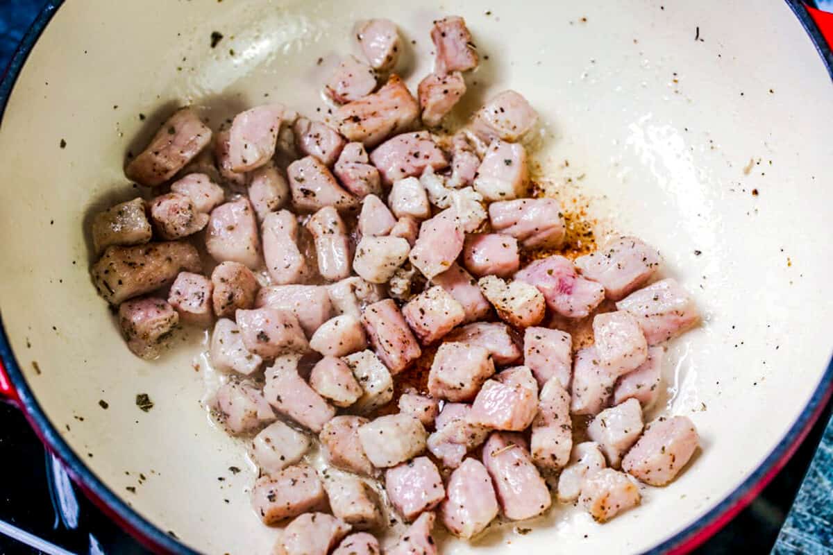 Pork browning in pan.