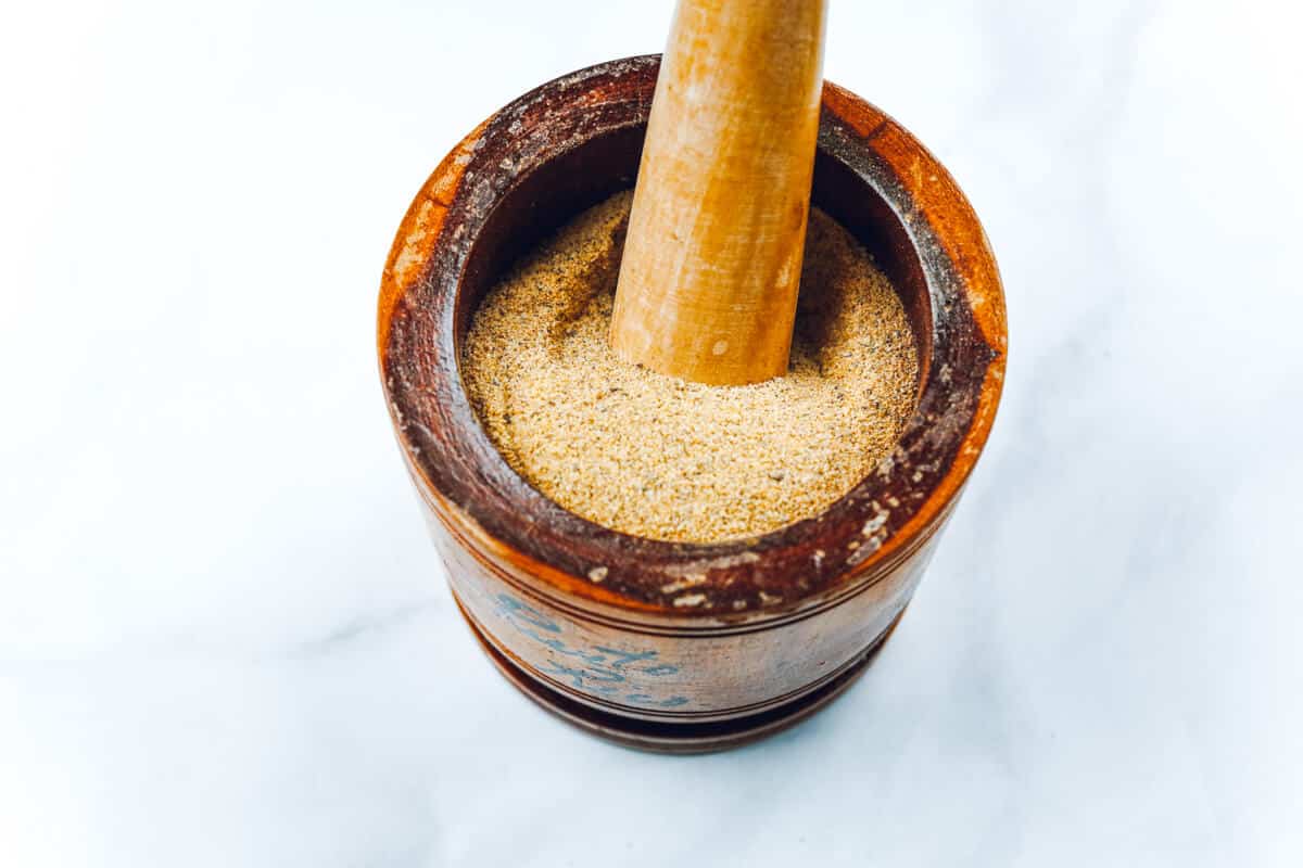 Mortar and pestle filled with a 7 spice blend.