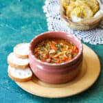 Small bowl full of sopa de fideo, a noodle soup with a rich tomato based broth and vegetables.
