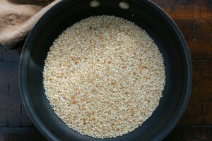 Toasted sesame seeds for horchata is in a small pan.