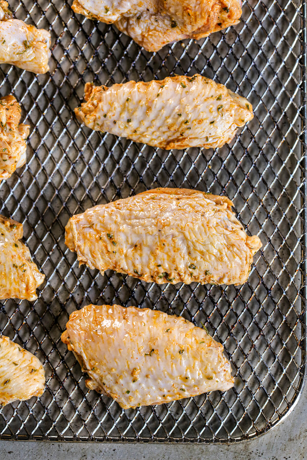 Raw and seasoned chicken wings on an Instant Pot rack