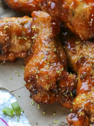 Close up of guava bbq wings garnished with lime zest