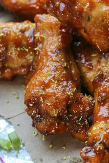 Close up of guava bbq wings garnished with lime zest