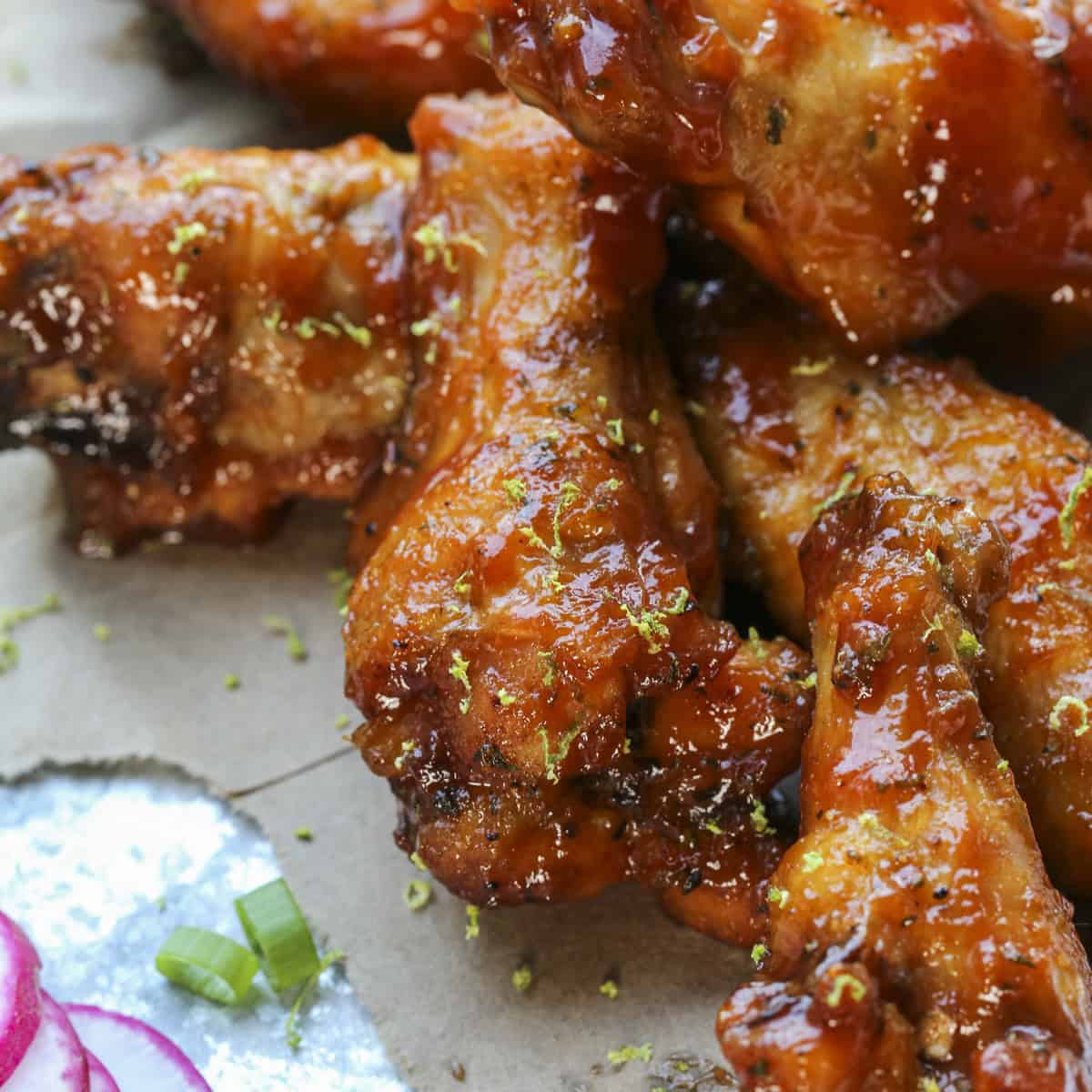 Close up of guava bbq wings garnished with lime zest