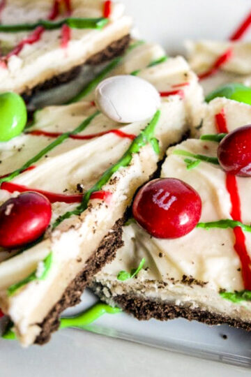 Chocolate graham crackers, with melted white chocolate on top, and swirls of red and green frosting, topped with holiday red, white, and green M&M candies.