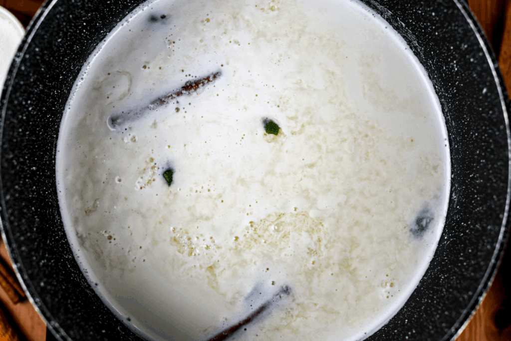 Milk with lemon juice and cinnamon sticks.