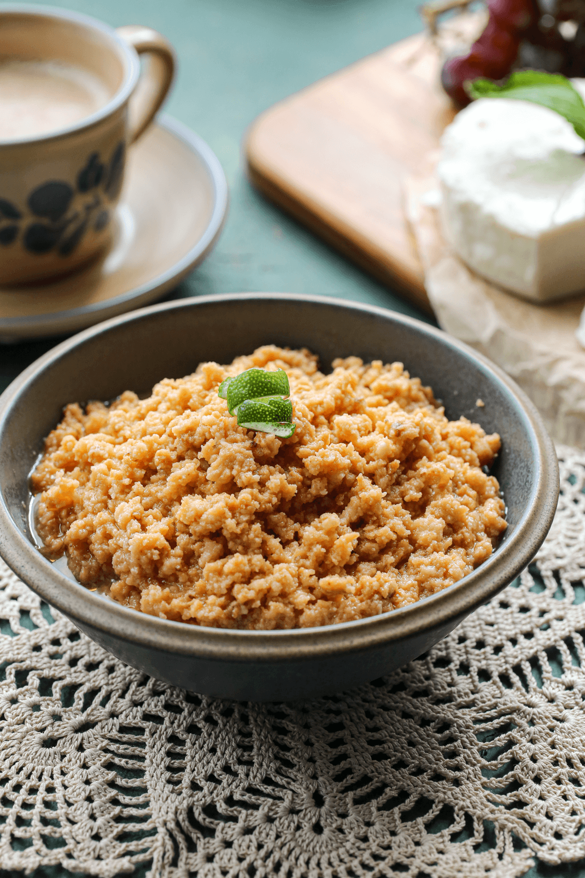 Hero image of a Cuban sour milk dessert recipe inside of a gray bowl with a green background
