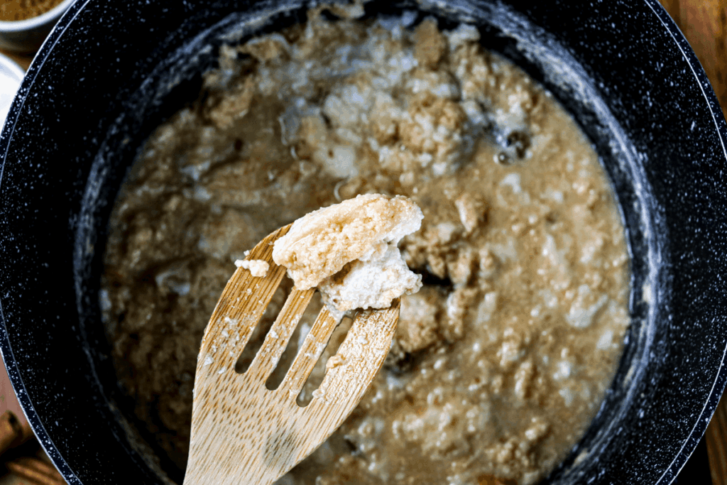 Milk curds are developing and caramelizing.