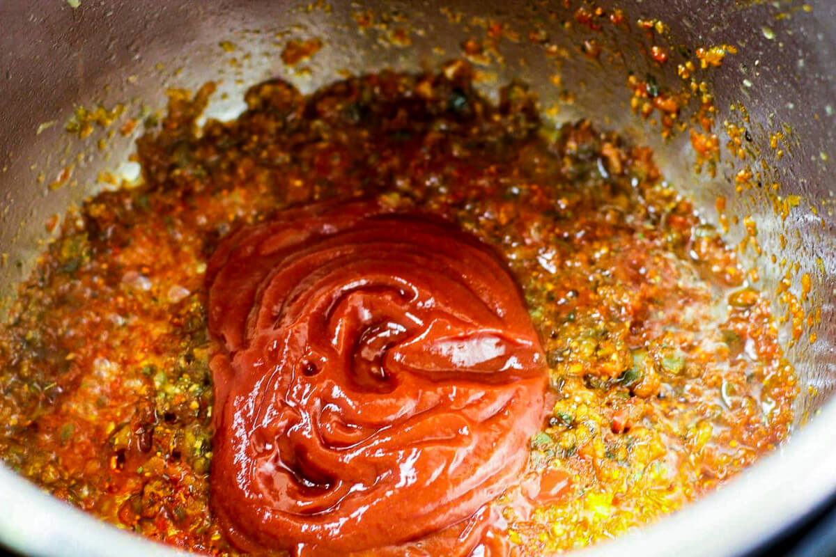 Instant pot has sofrito and tomato sauce in it.